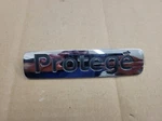 Mazda Oem 1999 2000 2001 Protege Rear Trunk Emblem Badge Logo Name BJ0E 51 720. Fixed Price $14.99.