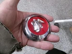 1949 Mercury Chrome / Red Trunk Lock Cover Part # 8M-704351. Fixed Price $99.00.