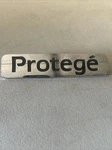 1999 2001 2002 2003 Mazda Protege Rear Trunk Nameplate Emblem BJ0E-51-720 Oem. Fixed Price $14.98.